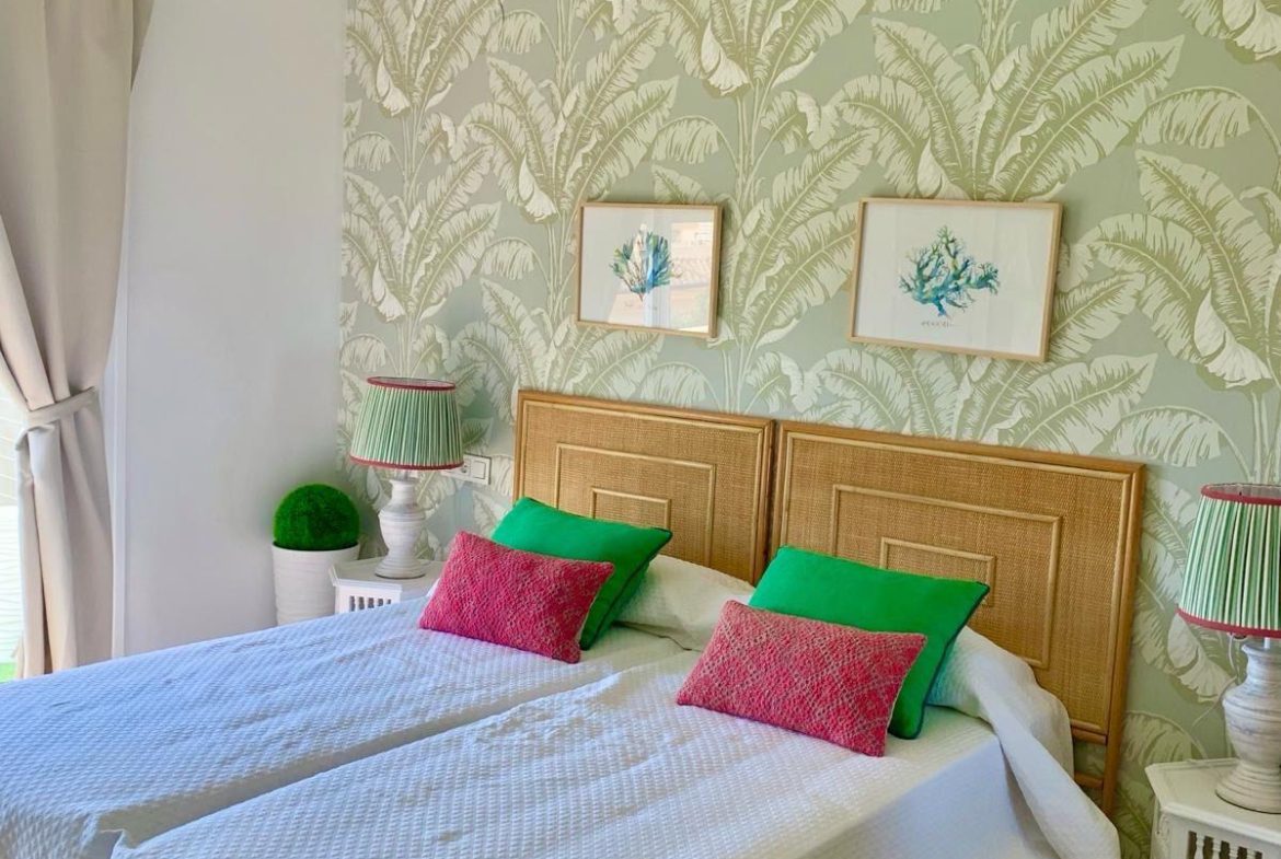 Bright bedroom with decorative wallpaper in a duplex apartment in San Roque Club Sotogrande.
