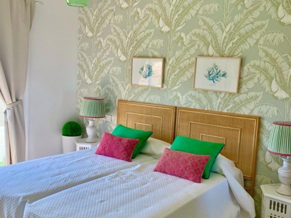 Bright bedroom with decorative wallpaper in a duplex apartment in San Roque Club Sotogrande.