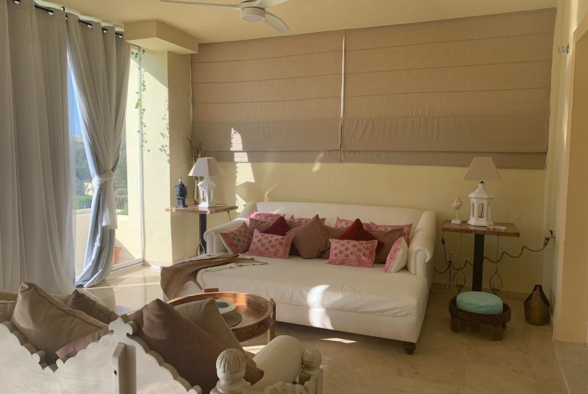 Bright living room with terrace and glass curtains in a furnished duplex apartment in San Roque Club Sotogrande.